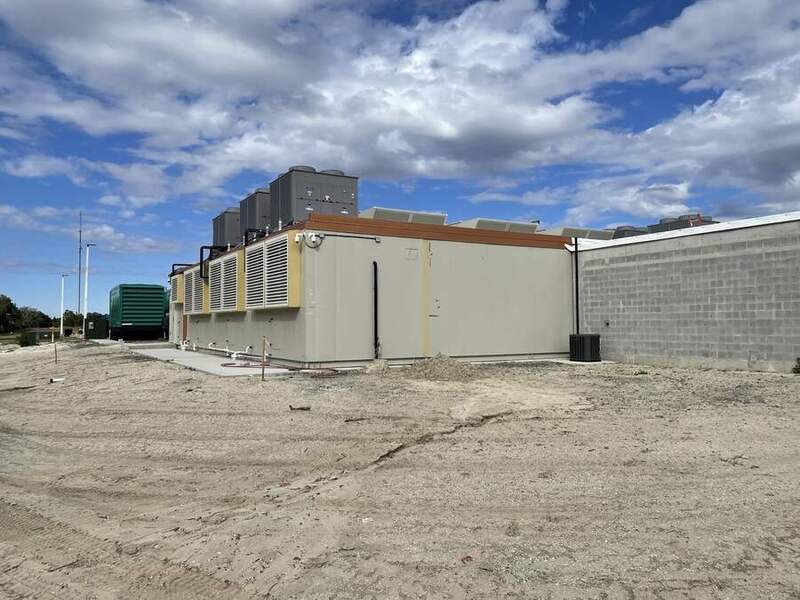 Fully assembled 900 kW modular data center unit staged on a concrete pad — actual DDCD inventory